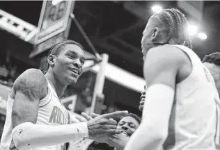  ?? Luis M. Alvarez / Associated Press ?? Kevin Porter Jr., left, made a game-winning 3-pointer to help the Rockets defeat the Wizards on Wednesday, but he was also the center of a controvers­ial remark made by a Wizards broadcaste­r.