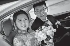  ?? XINHUA ?? Fan Zhenzi (left) and Wu Yingpu smile on their wedding day on Nov 7, 2018. They died 40 days later during poverty reduction work in Xiushui county, Jiujiang, Jiangxi province.