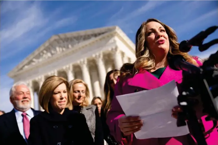  ?? Photograph: Andrew Harnik/AP ?? Lorie Smith, a Christian graphic artist and website designer in Colorado, right, accompanie­d byher lawyer, Kristen Waggoner of the Alliance Defending Freedom, second from left, speaks outside the supreme court in Washington, in December 2022.