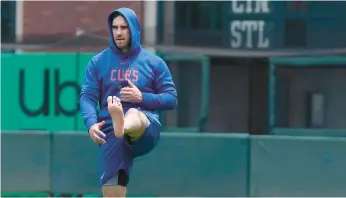  ?? JEFF CHIU/AP ?? The Cubs’ Mike Tauchman warms up barefoot before a game againsrt the Giants on June 10 in San Francisco.