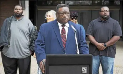  ?? RICK KAUFFMAN — DIGITAL FIRST MEDIA ?? Rev. Dr. Horace Strand, Sr. of the Faith Temple Holy Church, backed by supporters at Chester High Monday, called for the Chester Upland School District to illustrate ‘respect and dignity’ in the aftermath of the decision to not renew Larry Yarbray’s...