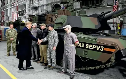  ?? AP ?? US President Donald Trump greets workers as he tours the Lima Army Tank Plant in Lima, Ohio yesterday.