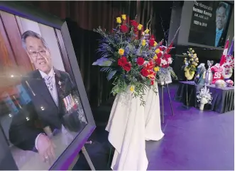  ?? JIM WELLS ?? A stage display at the state memorial for former Alberta Lt.-Gov. Norman Kwong includes football mementoes from his days as a CFL player and executive.