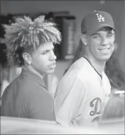  ?? Christian K. Lee Los Angeles Times ?? LONZO BALL SMILES in the Dodgers’ dugout with younger brother LaMelo before the first pitch.