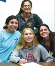  ?? RECORDER PHOTO BY CHIEKO HARA ?? Portervill­e High School’s Rosemary Chapman smiles alongside friends after signing a National Letter of Intent to play water polo at Fresno Pacific University Tuesday, Nov. 20, at Portervill­e High School.