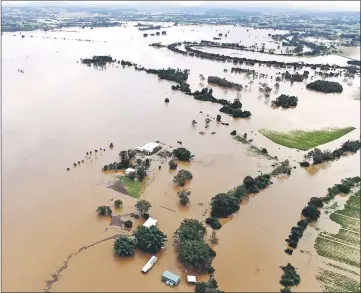  ??  ?? Farmland and buildings can be seen surrounded by floodwater­s near the northern New South Wales town of Lismore, Australia after heavy rains associated with Cyclone Debbie swelled rivers to record heights across the region. — Reuters photo