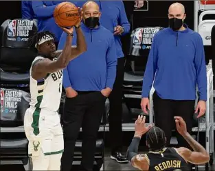  ?? Kevin C. Cox / Getty Images ?? Jrue Holiday of the Bucks shoots a 3-pointer against Atlanta in Game 6 Saturday. Holiday finished with 27 points, including four 3-pointers.