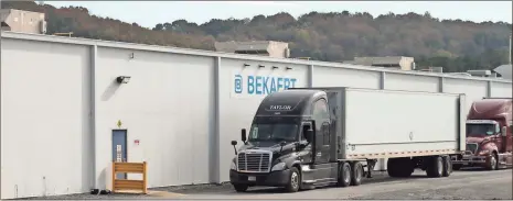  ?? / Doug Walker ?? Trucks line up near a loading dock at the Bekaert steel wire plant in Rome. Bekaert is one of the community’s first foreign-owned industries.