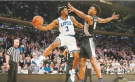  ?? Elsa, Getty Images ?? Xavier’s Quentin Goodin passes the ball around Providence’s Rodney Bullock during the Big East semifinals Friday.