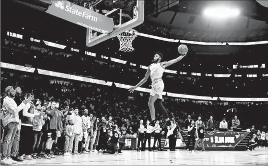  ?? CHRIS SWEDA/CHICAGO TRIBUNE ?? Heat player Derrick Jones Jr. competes in the Slam Dunk Contest at NBA All-Star weekend on Saturday at the United Center.