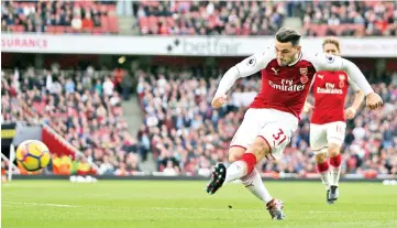  ??  ?? Arsenal’s German-born Bosnian defender Sead Kolasinac shoots to score their first goal during the English Premier League football match between Arsenal and Swansea City at the Emirates Stadium in London on October 28, 2017. - AFP photo
