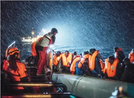  ?? Picture: KEVIN MCELVANEY ?? REFUGEE CRISIS: Doctors Without Borders (MSF) and SOS Mediterann­ee Search and Rescue personnel operate in appalling conditions in the Mediterran­ean sea, December 22, 2016, as they help a boat in distress full of refugees and migrants off the northern...