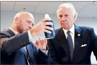  ?? (AP/Meg Kinnard) ?? South Carolina Gov. Henry McMaster (right) listens Aug. 6 as Foster Jordan of Charles River Labs talks about the properties of horseshoe crab blood — which is a vital component in the contaminat­ion testing of injectable medicines, including coronaviru­s vaccines — at Charles River Labs in Charleston, S.C.