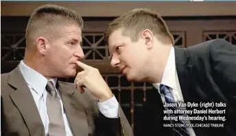  ??  ?? Jason Van Dyke ( right) talks with attorney Daniel Herbert during Wednesday’s hearing. NANCY STONE/ POOL/ CHICAGO TRIBUNE