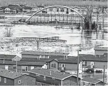  ?? VINCENT MCDERMOTT • POSTMEDIA NEWS ?? Flood waters from the Clearwater River cover the Ptarmigan Trailer Park in Waterways, Alta. on Monday.