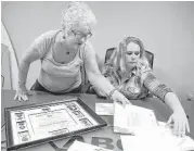  ?? Carline Jean / Sun Sentinel ?? Darlene Stosik, left, looks over items from her brother, Pfc. Geoffrey Saunders, who was killed in Vietnam in 1968. Meghan Burns, right, found them.