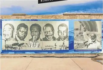  ?? Picture: 123rf.com/mark52 ?? WONDER WALL A banner on a wall at Robben Island, Cape Town, showing some of its more legendary prisoners .