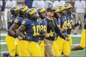  ?? TONY DING / ASSOCIATED PRESS ?? Michigan in three years under Jim Harbaugh (center) is 28-11, only a slightly better record at this point than his predecesso­r, Brady Hoke.