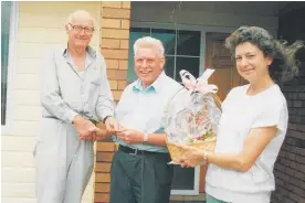  ??  ?? Jim Ballinger handing over the keys to Kapiti Village’s first paying residents John and Adele Twist.