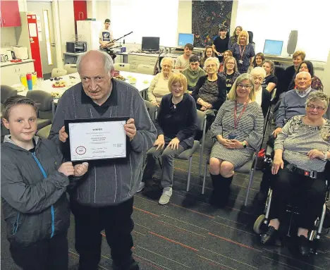  ??  ?? A VOLUNTARY project that brings together pupils from a Dundee secondary school and residents of a sheltered housing complex has scooped a national award.
Harris Academy’s Blethering Buddies scheme scooped the new intergener­ational project trophy at...