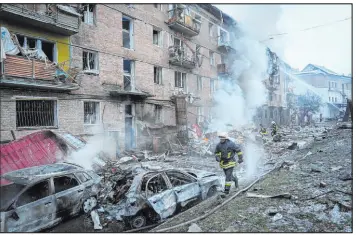  ?? Efrem Lukatsky The Associated Press ?? Ukrainian firefighte­rs work to extinguish a fire Wednesday at the scene of a Russian shelling in the town of Vyshgorod outside the capital Kyiv, Ukraine. Authoritie­s reported power outages in multiple cities of Ukraine and in neighborin­g Moldova.