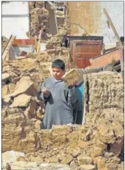  ?? AGENCIES ?? L-R: Injured survivors being transporte­d in a Pakistan’s army helicopter following an earthquake in the remote mountainou­s district of Harnai in Balochista­n; a boy stands amid the rubble of collapsed houses after the disaster.