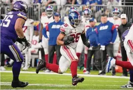  ?? Charlie Neibergall/Associated Press ?? Giants running back Saquon Barkley runs up field during the first half against the Vikings on Jan. 15 in Minneapoli­s.