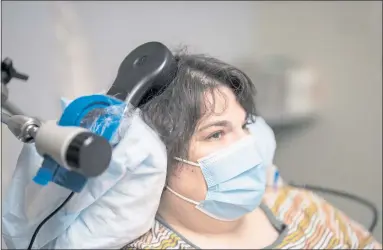  ?? MAURICE RAMIREZ — UCSF ?? Sarah, a clinical trial participan­t, is seen at an appointmen­t at UC San Francisco’s Langley Porter Psychiatri­c Institute. She is being treated for depression through a procedure called deep brain stimulatio­n.