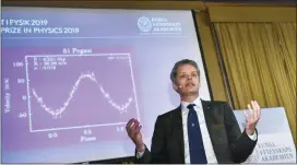  ?? CLAUDIO BRESCIANI / TT VIA AP ?? Ulf Danielsson, member of the Nobel committee talks during the announceme­nt of the winners of the 2019 Nobel Prize in Physics during news conference at the Royal Swedish Academy of Sciences in Stockholm, Sweden, on Tuesday Oct. 8, 2019. The 2019 Nobel Prize in Physics is awarded to James Peebles, Michel Mayor and Didier Queloz.