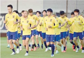  ?? — AFP ?? Japan defenders Maya Yoshida (L) and Yuto Nagatomo (2nd L) take part in a training session with teammates at the Al Sadd SC training grounds in Doha.