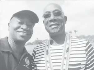  ?? ?? Being in the right place at the right time. Quado Vancooten with Prime Minister of Trinidad and Tobago Keith Rowley who visited Fairview Village on Thursday