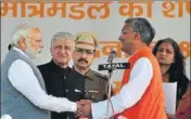  ??  ?? Prime Minister Narendra Modi greets the 9th CM of Uttarakhan­d Trivendra Singh Rawat (right) during swearing in ceremony at Parade Ground in Dehradun, India, on Saturday. VINAY SANTOSH KUMAR