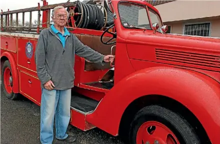  ??  ?? Northland Firehouse Museum curator Brian Denton with a Ford 1939 V8 fire engine.