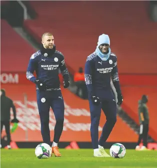  ?? SHAUN BOTTERILL/AFP VIA GETTY IMAGES ?? Manchester City player Benjamin Mendy, right, hosted friends on New Year's Eve, but manager Pep Guardiola says Mendy was likely just one many in England to break lockdown rules.