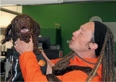  ??  ?? Search and rescue dog Bomber is reunited with Brad Saville at Queenstown Airport after being stranded in the United States for two months.