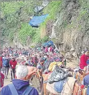  ?? ?? (From left) A SDRF team escorts pilgrims near Gaurikund on Tuesday; mules and horses operating on the Gaurikiund-Kedarnath route.