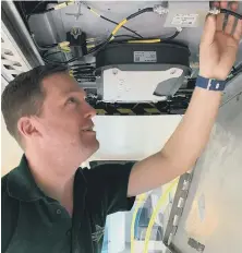  ??  ?? GTR Wireless engineer Robin Hayman fitting the wi-fi