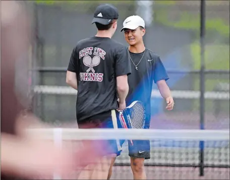  ?? SARAH GORDON/THE DAY ?? East Lyme No. 2 doubles teammates David Chung, right, and Riley Walsh celebrate a point during Monday’s ECC Division I match against Stonington at East Lyme. Chung and Walsh were victorious as the Vikings won 6-1. Visit ww.theday.com to view a photo gallery.