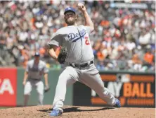  ?? Michael Macor / The Chronicle ?? Dodgers starter Clayton Kershaw held the Giants to three singles in seven innings to prevent a sweep by San Francisco.