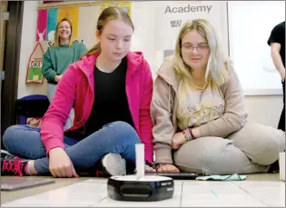  ?? NEWS PHOTO BRENDAN MILLER ?? Grade 8 students Samantha Martin and Jordyn Ohs take part in a robotics workshop held by the Geek Squad Academy at Dr. Roy Wilson Learning Academy on Friday.