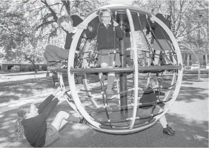  ??  ?? Grade 5 students from Christ Church School enjoy the playground on the former tent city site at the Victoria Courthouse. Researcher­s have found play environmen­ts where kids can take risks promote increased playtime, social interactio­ns, creativity and...