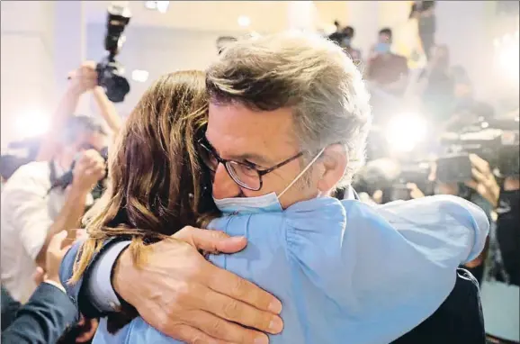  ?? LAVANDEIRA JR / EFE ?? Alberto Núñez Feijóo se abrazó a su mujer una vez concluido el escrutinio que le da de nuevo la mayoría absoluta