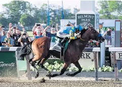  ?? AP ?? American Pharoah ridden by Victor Espinoza crosses the finish line at Belmont Park.