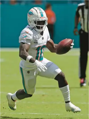  ?? JOHN MCCALL/SOUTH FLORIDA SUN SENTINEL ?? Dolphins wide receiver Tyreek Hill runs for yards after a catch against the Giants during the first half on Sunday at Hard Rock Stadium in Miami Gardens.