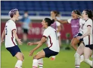  ?? SILVIA IZQUIERDO — THE ASSOCIATED PRESS ?? United States’ Megan Rapinoe, left, celebrates with teammates after scoring the winning goal and defeating the Netherland­s in a penalty shootout during a women’s quarterfin­al soccer match at the 2020Summer Olympics, July 30, in Yokohama, Japan.