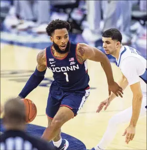  ?? John Peterson / Associated Press ?? UConn guard R.J. Cole (1) dribbles the ball against Creighton guard Marcus Zegarowski (11) on Saturday.