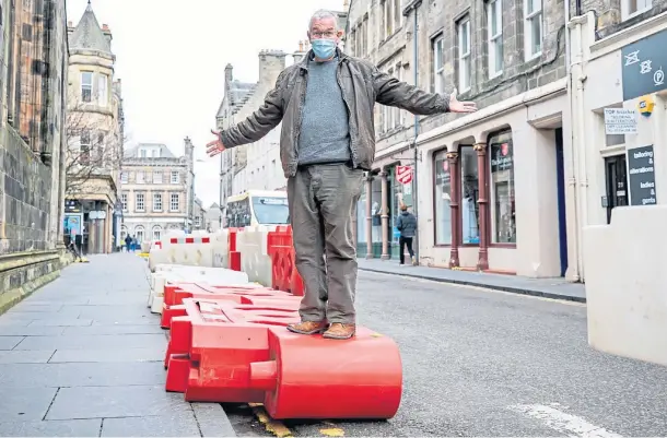  ??  ?? HAZARD: Eric Milne and the bollards which do not appear to be providing pedestrian­s with a safe route on Church Street. Pictures by Kim Cessford.