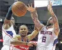  ??  ?? ASSOCIATED PRESS Wizards guard Ramon Sessions loses control of the ball after running into the Hawks’ Pero Antic (right) on Tuesday.