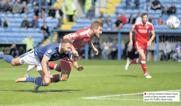  ??  ?? Carlisle United’s Hallam Hope sends a flying header towards goal. PICTURES: Mark Fuller