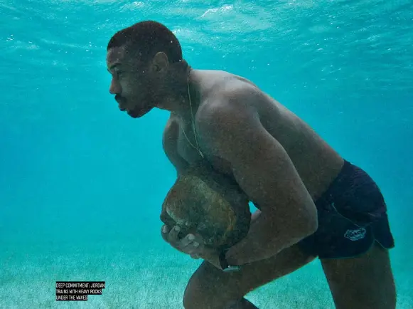  ??  ?? DEEP COMMITMENT: JORDAN TRAINS WITH HEAVY ROCKS UNDER THE WAVES